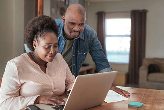 couple paying bills at home
