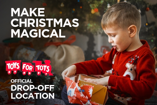 Little boy opens gift toys for tots